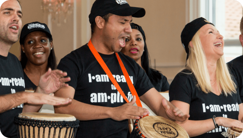 Drum Cafe teambuilding session participants drumming